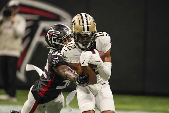 Sep 11, 2022; New Orleans Saints wide receiver Chris Olave (12) catches a two point conversion in front of Atlanta Falcons safety Jaylinn Hawkins (32). Mandatory Credit: Dale Zanine-USA TODAY Sports